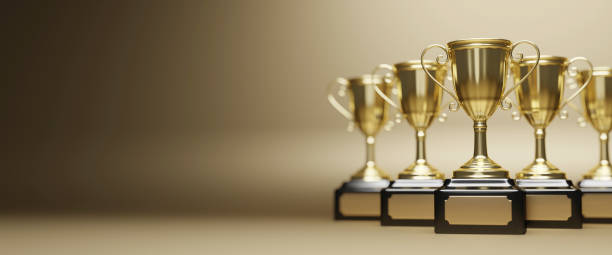 istock Golden trophy cup on gold background. copy space for text. 3d rendering. 1296652572