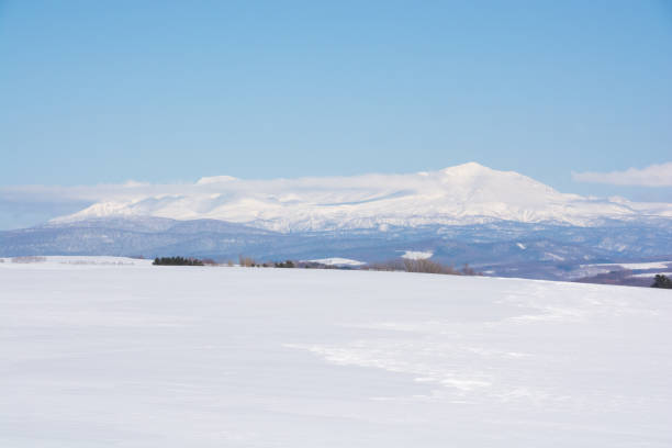 istock Snowfields and snowy mountains in early spring on a sunny day 1296658537