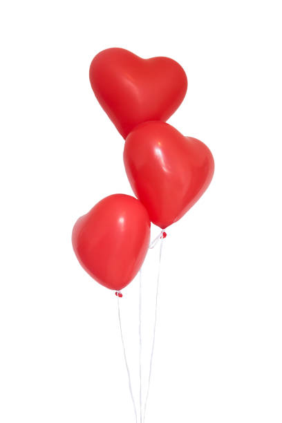 istock Three heart shaped red balloons on white background 1296659423
