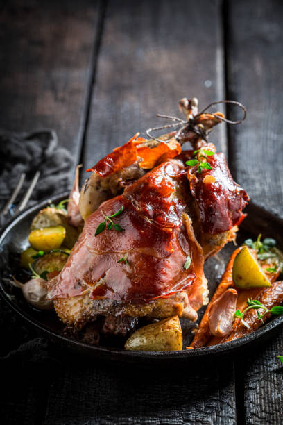 istock Closeup of grilled pheasant with bacon and vegetables 1296660135
