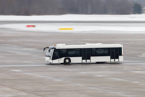 Airfield bus while driving through the airport. Shuttle bus for transportation of passengers at terminal. Airport service.