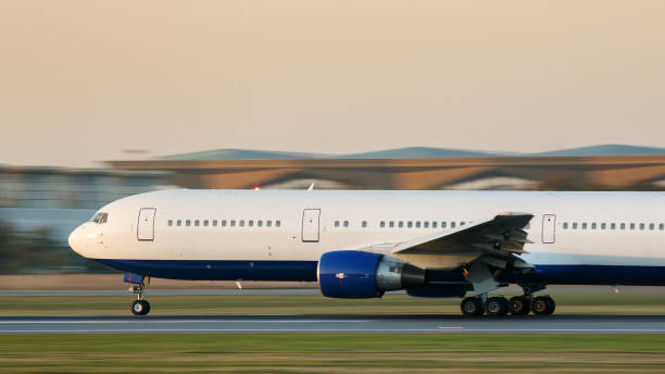 istock passenger airplane taxing on runway for take off at sunset, side view, in motion 1296662741