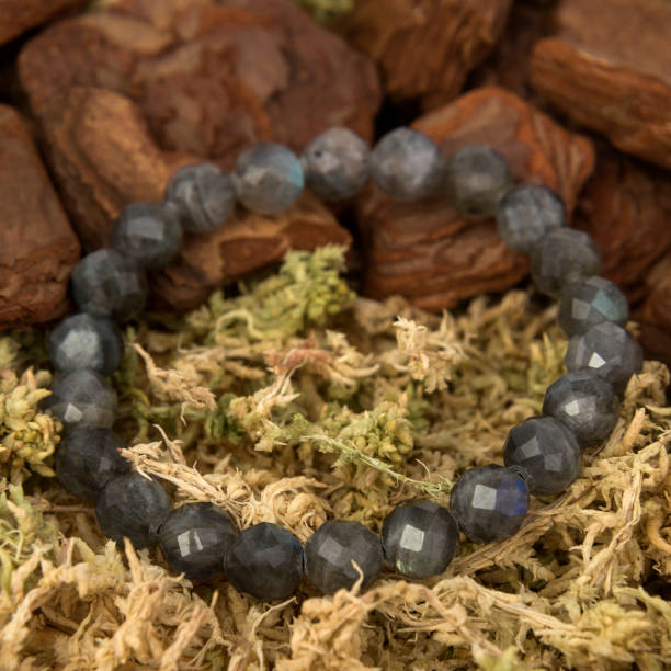 istock Stone bracelet isolated on decorated wooden, moss background 1296667509