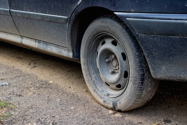 istock Dirty wheel on a black car close up 1296667946