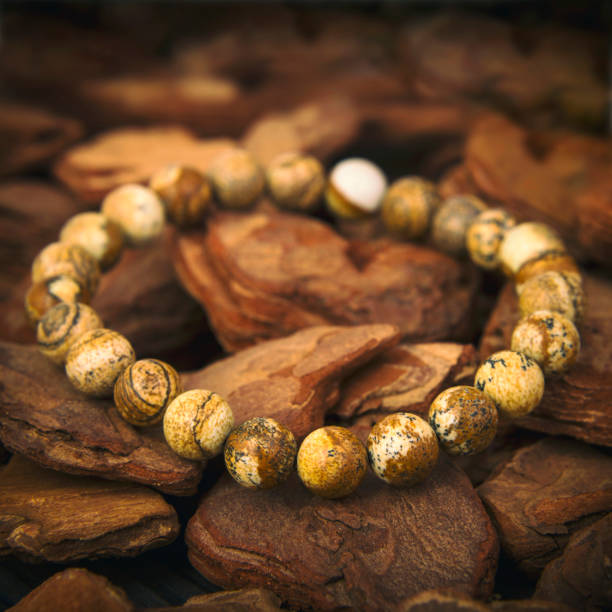 istock Stone bracelet on decorated wooden background 1296668069