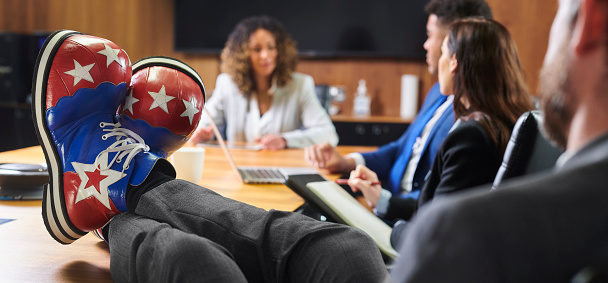 business colleague with clown shoes on in meeting