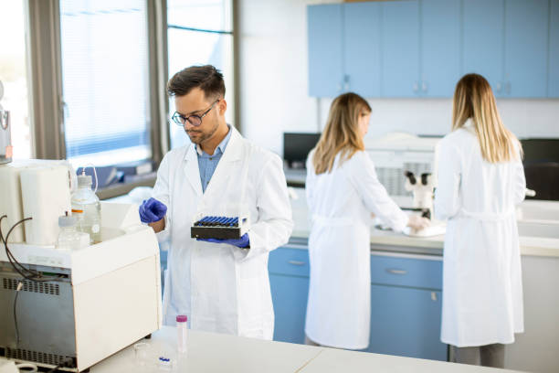 istock Researcher in protective workwear standing in the laboratory and analyzing liquid samples 1296671421