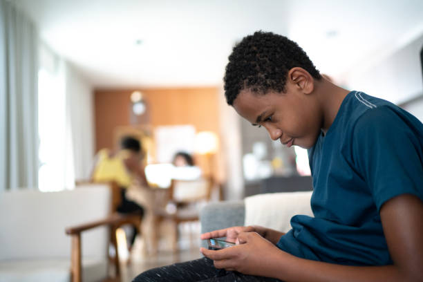 Teenager boy using smartphone at home Teenager boy using smartphone at home bad posture stock pictures, royalty-free photos & images