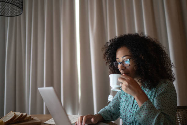 istock Business woman working from home drinking coffee 1296671502