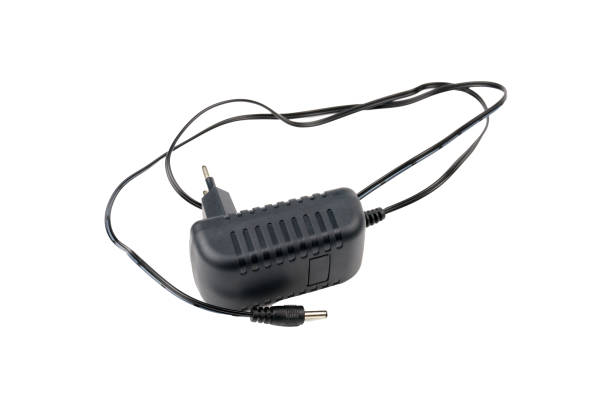 istock Black power supply unit of electrical appliance isolated on white background 1296672561