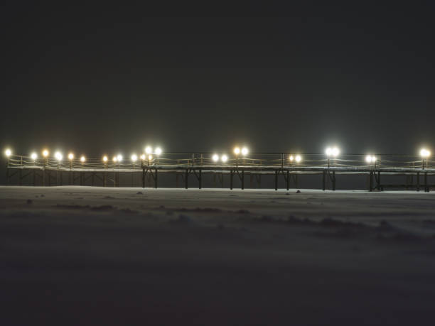 istock Wooden bridge in snowy night 1296674241