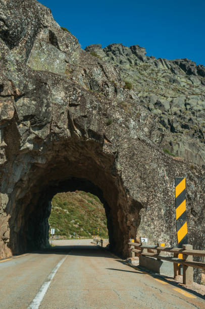 istock Road on rocky landscape passing through tunnel 1296675457