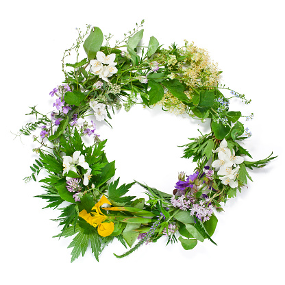 Beautiful wreath with colorful flowers isolated on a white background. Midsummer celebration concept, summer decoration.