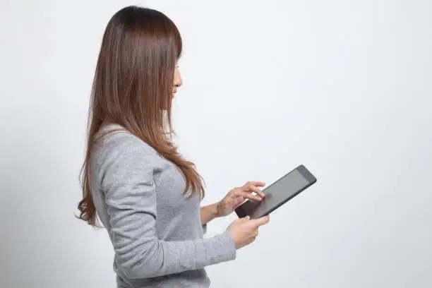 Photo of Young Asian woman with a computer tablet.
