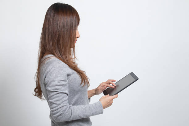 young asian woman with a computer tablet. - ped imagens e fotografias de stock