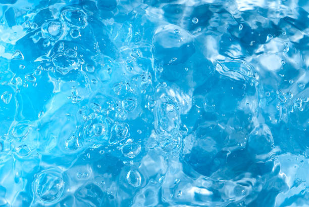 istock blue transparent clean drinking water abstract background. water surface with air bubbles background 1296678865