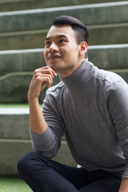 istock asian man thinking, sitting and looking up 1296679441