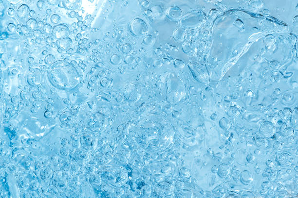 istock blue transparent clean drinking water abstract background. water surface with air bubbles background 1296679846