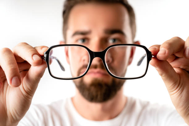 istock Young man holding eyeglasses in his hands 1296680576