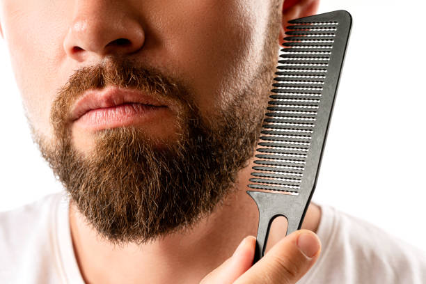 istock Well groomed man combing his beard 1296681014