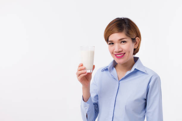 healthy asian woman holding glass of milk - m09 imagens e fotografias de stock