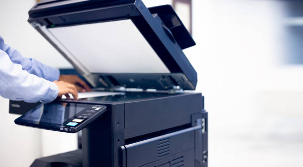 istock Bussiness man Hand press button on panel of printer, printer scanner laser in office. 1296681724