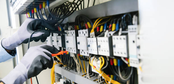 istock Electrical engineers test electrical installations and wiring on protective relays, measuring them with a multimeter. 1296681897