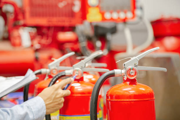 istock Engineer inspection Fire extinguisher and fire hose,Ready to use in the event of a fire.Safety first concept. 1296681908