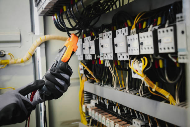 istock Electrical engineers test electrical installations and wiring on protective relays, measuring them with a multimeter. 1296681909