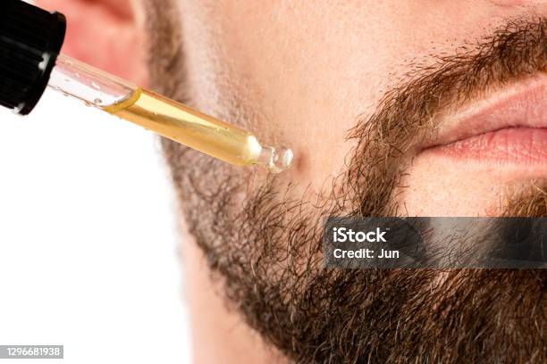 Male Face And Pipette With A Oil For A Beard Growth Stock Photo - Download Image Now