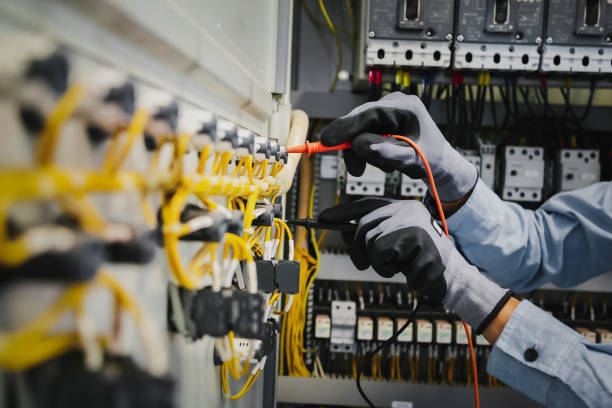 istock Electrical engineers test electrical installations and wiring on protective relays, measuring them with a multimeter. 1296681959