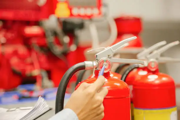 Engineer inspection Fire extinguisher and fire hose,Ready to use in the event of a fire.Safety first concept.