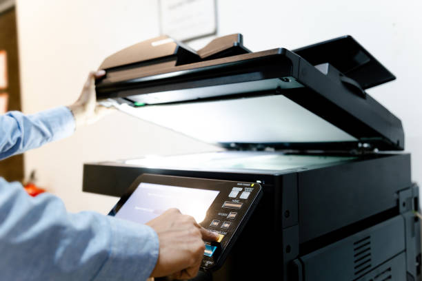 istock Bussiness man Hand press button on panel of printer, printer scanner laser in office copy machine supplies start concept. 1296681988