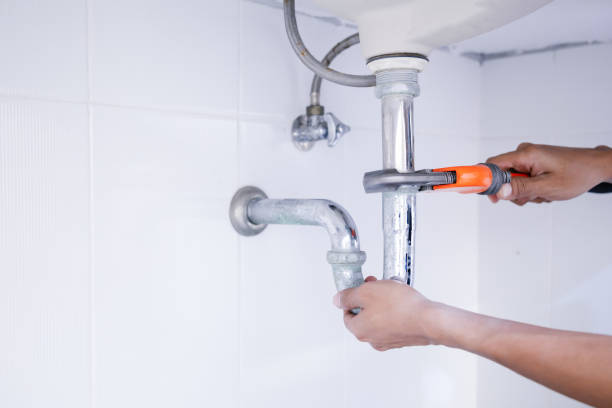 Plumber working in the bathroom, plumbing repair service. Plumber working in the bathroom, plumbing repair service, repairing leaking sinks with adjustable wrench, assemble and install concept. pipe smoking pipe stock pictures, royalty-free photos & images