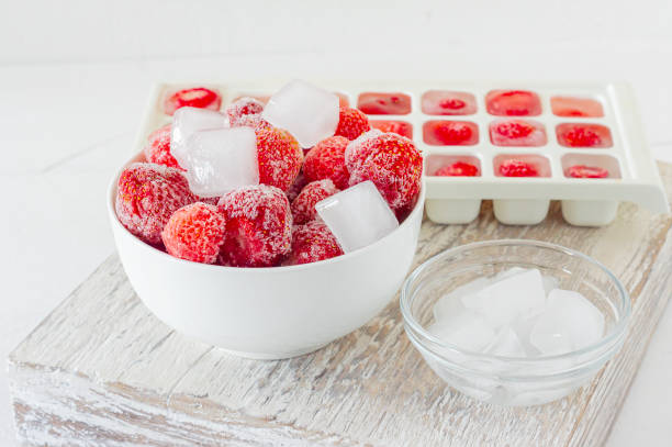 istock Frozen strawberry with crystals of ice on white background 1296683163