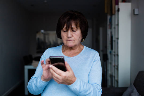 istock Senior woman standing holding a digital tablet and making a video conference 1296683366