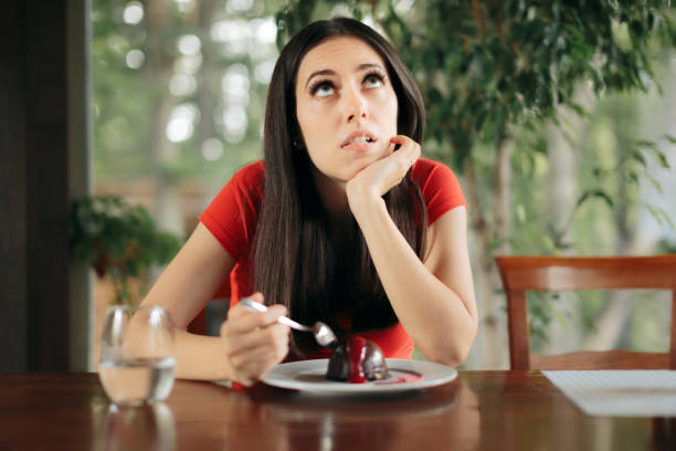 istock Woman Feeling Guilty for Eating Chocolate Cake 1296684843