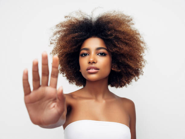 istock Beautiful young girl saying to stop 1296685020