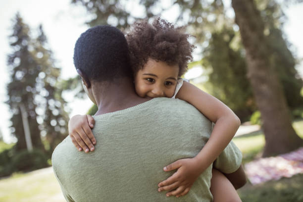 istock Cute curly kid sitting playing with her dad and feeling happy 1296686429
