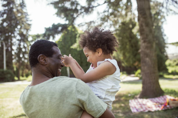 istock Sweet curly kid sitting playing with her dad and feeling happy 1296686433