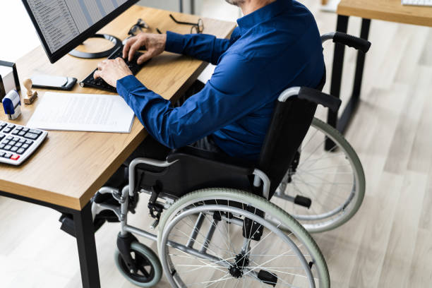 istock Disabled Handicapped Man In Wheelchair Working 1296686824