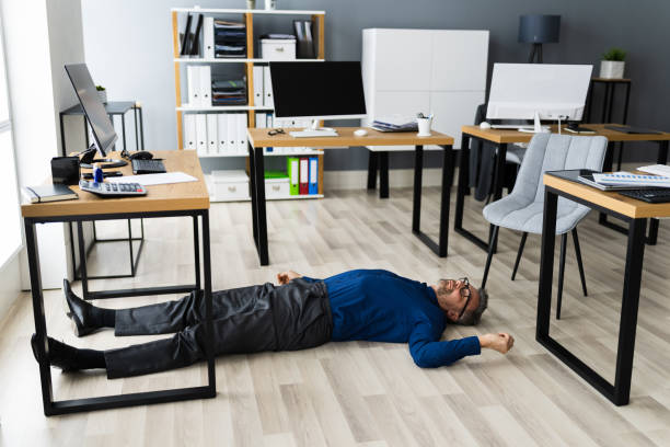 istock Office Slip And Fall Accident. Fainted Man 1296686832
