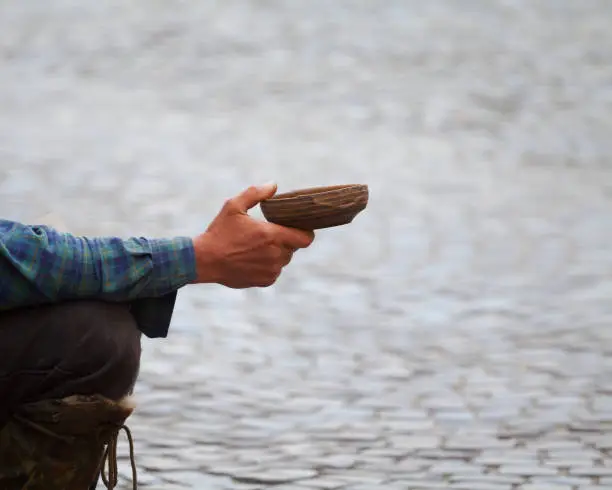 Hand of homeless caucasian man begging