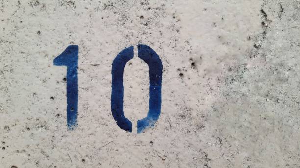istock Number 10 on white concrete. 1296687711