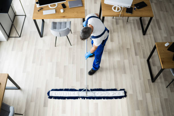 istock Male Janitor Mopping Floor In Face Mask 1296687858