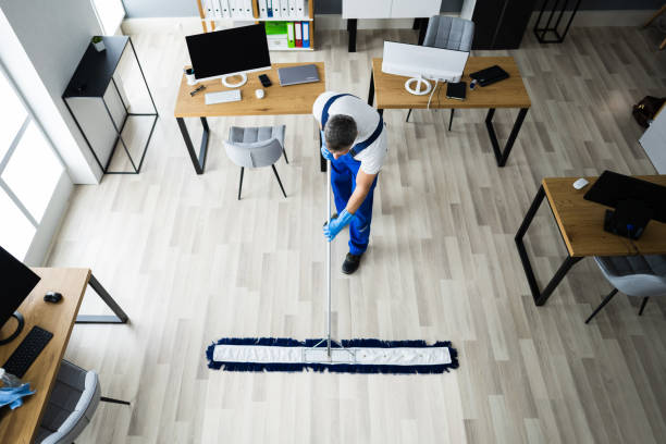 istock Male Janitor Mopping Floor In Face Mask 1296687863