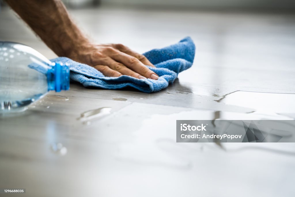 Hand Cleaning Water On House Floor Surface Hand Cleaning Water On House Floor Surface. Laminate Damage Spilling Stock Photo