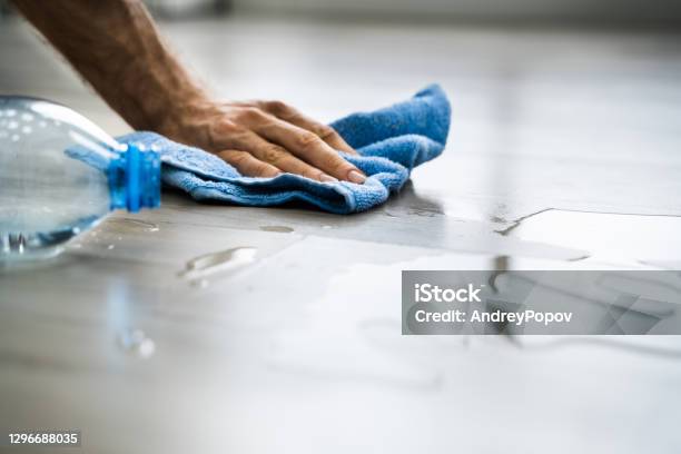 Hand Cleaning Water On House Floor Surface Stock Photo - Download Image Now - Spilling, Cleaning, Flooring