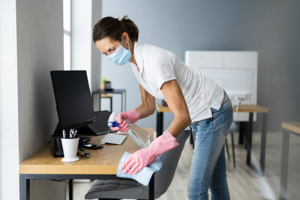 istock Office Desk Cleaning Service. Professional Janitor 1296689048