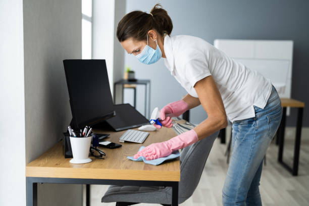 istock Office Desk Cleaning Service. Professional Janitor 1296689050